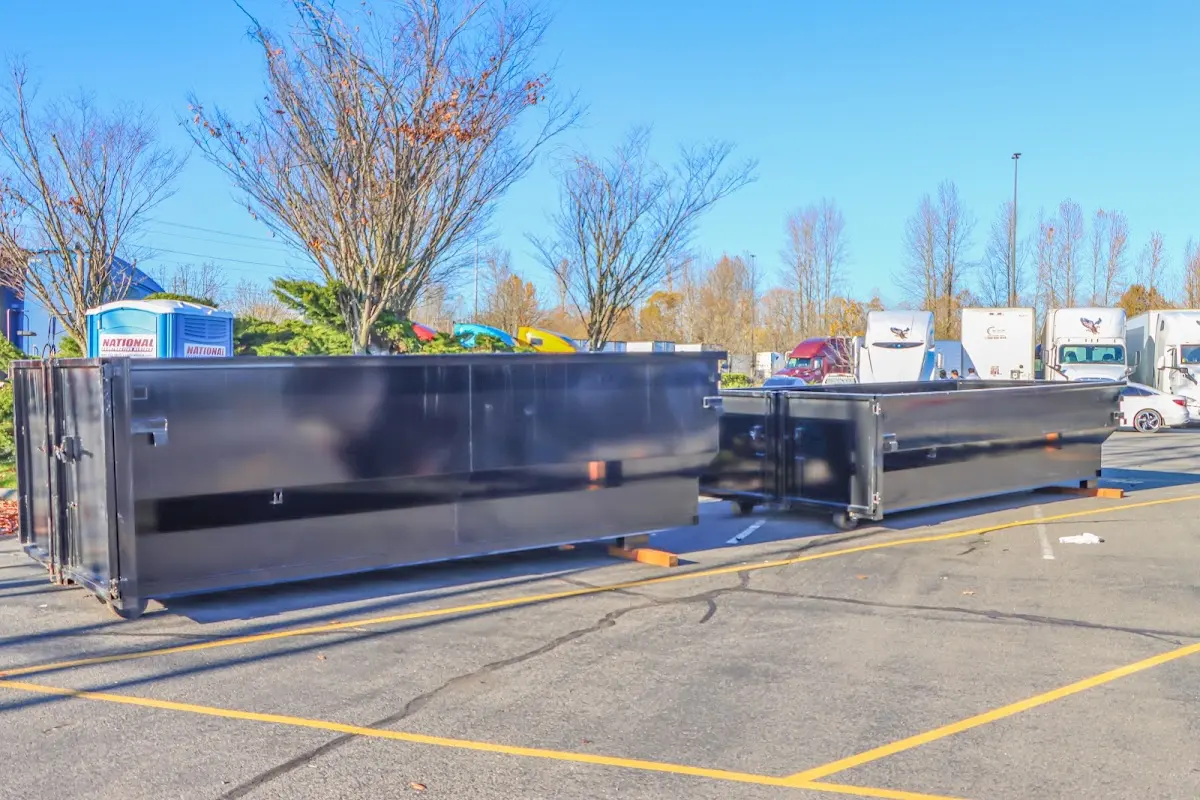 Professional dumpster rental service with roll-off container on residential driveway in Canterbury